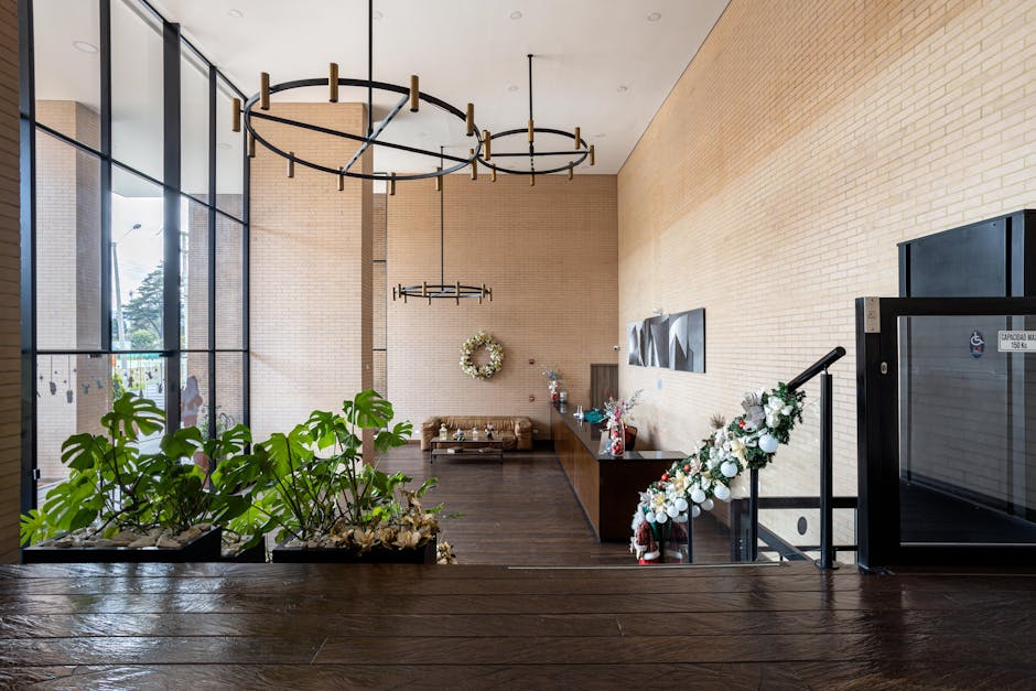Spacious modern lobby in Bogotá featuring chic furniture, plants, and contemporary lighting.