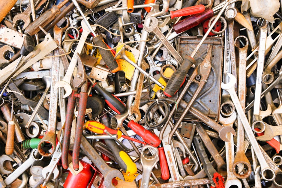 A vibrant assortment of various hand tools arranged in a pile. Ideal for construction themes.